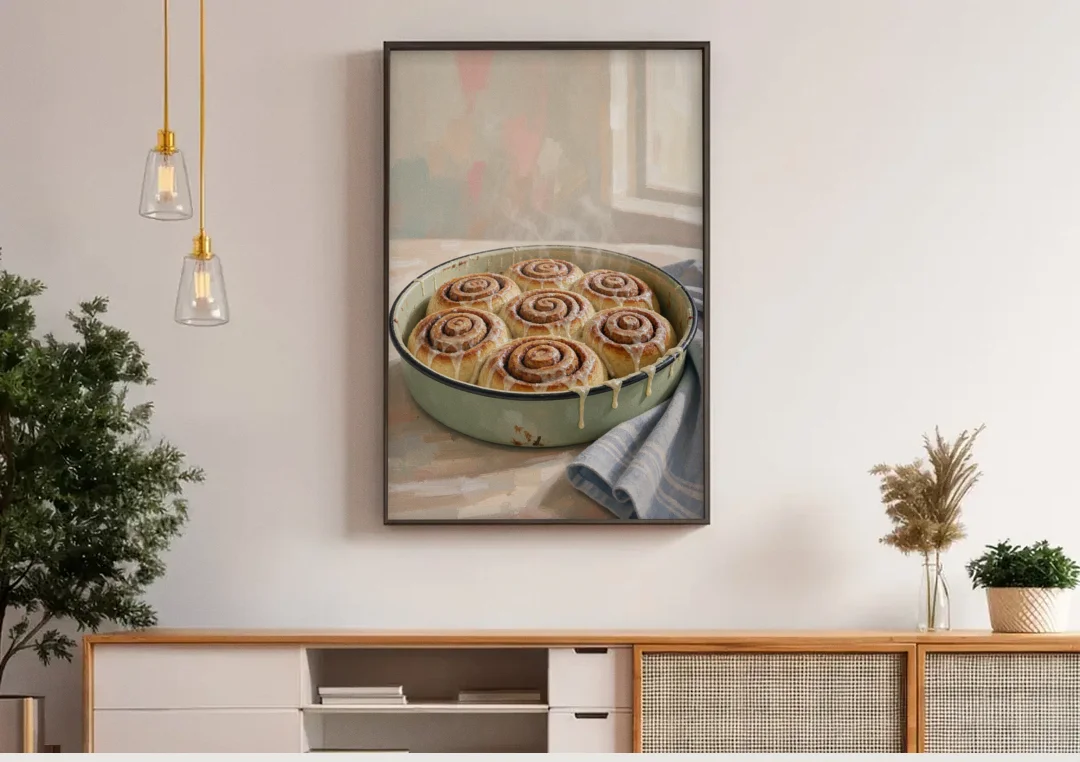 Cinnamon Roll Painting in a Sage Enamel Pan canvas wall art above a wooden sideboard under pendant lights