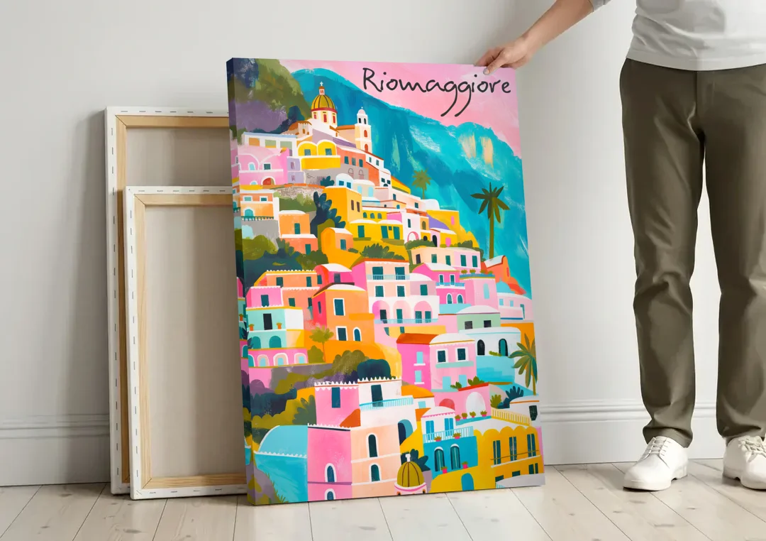 Cinque Terre Wall Art in Candy Colors canvas wall art leaning against a wall next to blank canvases