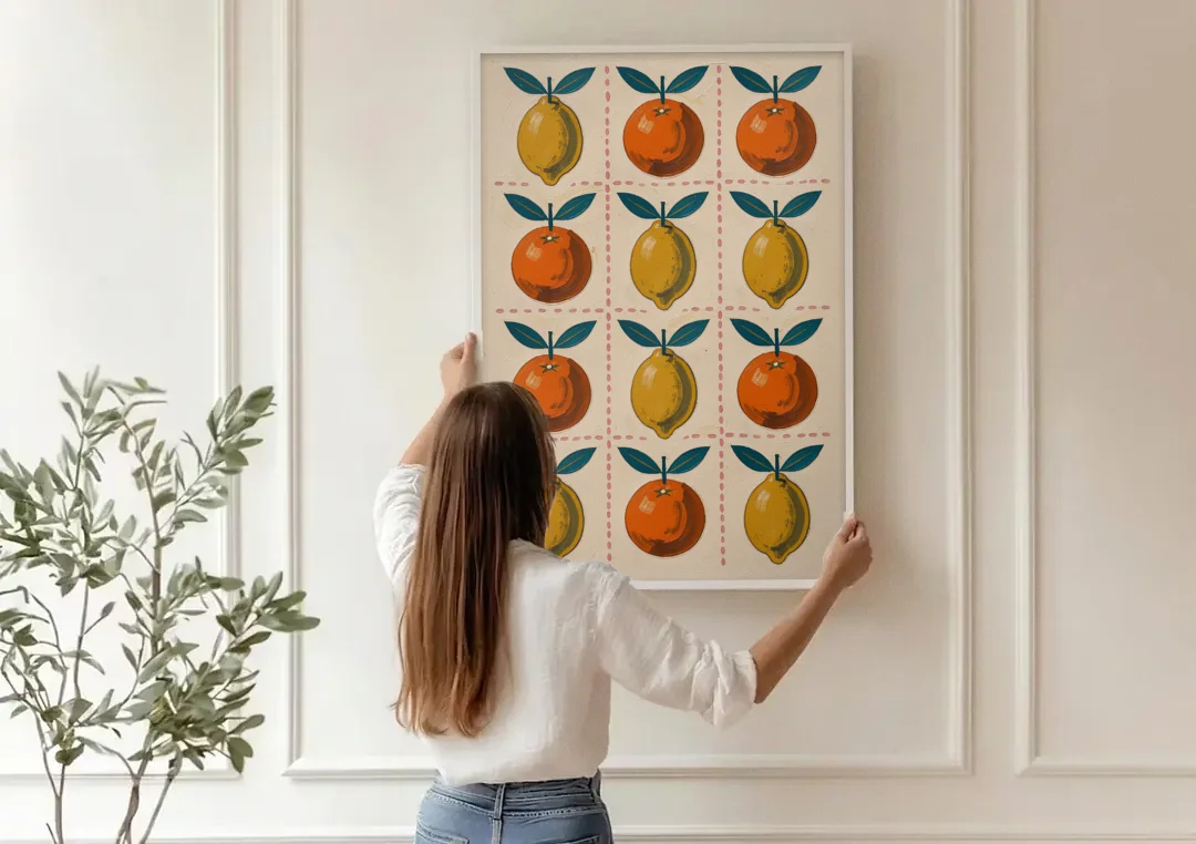 Citrus Wall Art with Lemons and Oranges canvas wall art being hung on a paneled wall