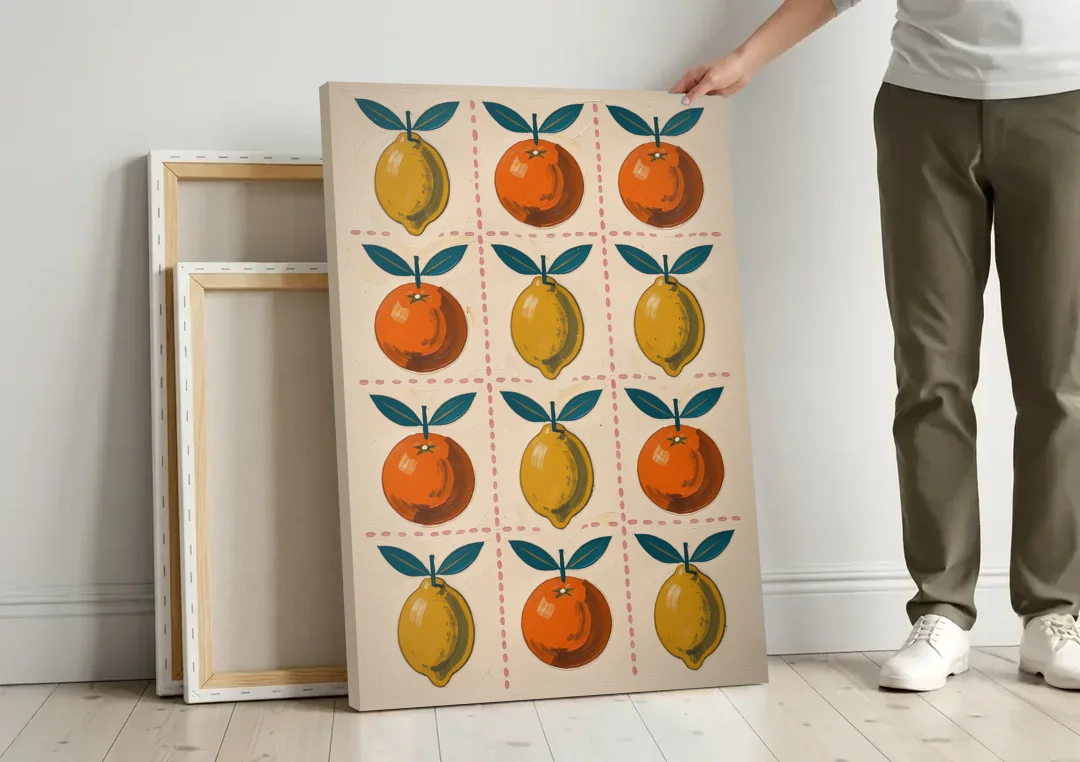 Citrus Wall Art with Lemons and Oranges canvas wall art leaning against a wall next to blank canvases