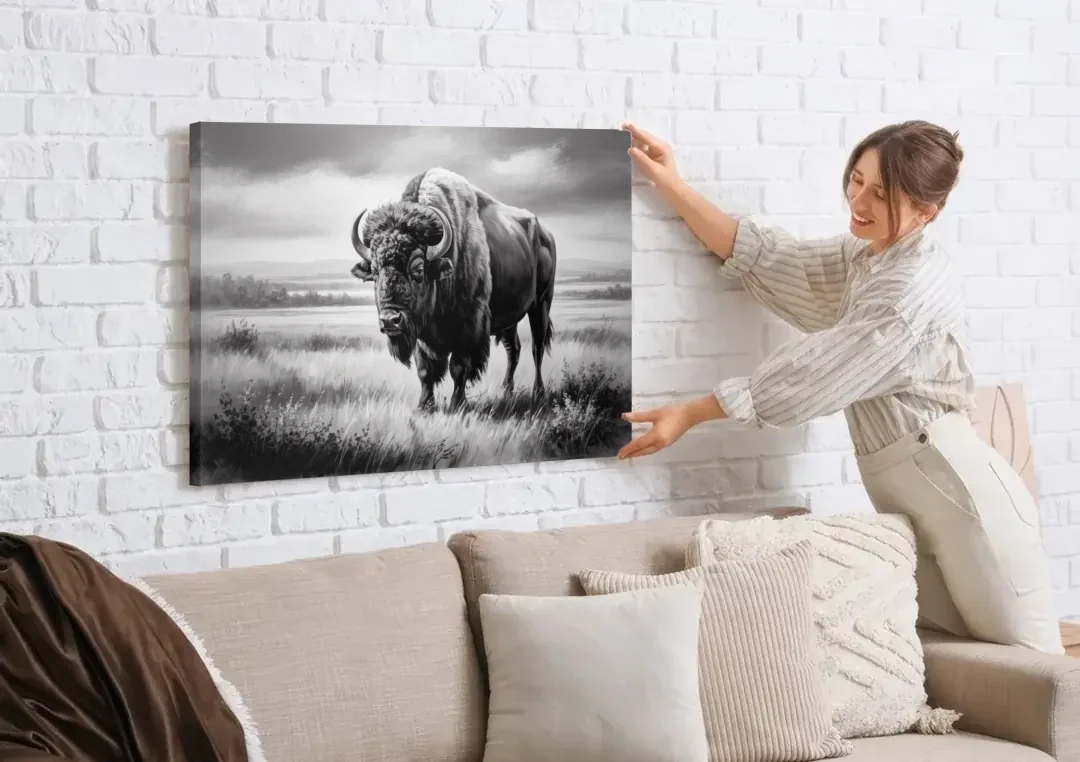 Classic Black and White Buffalo canvas wall art being hung on a white brick wall above a sofa