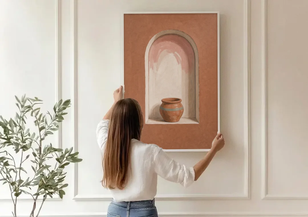 Clay Pot in a Terracotta Arched Niche canvas wall art being hung on a paneled wall