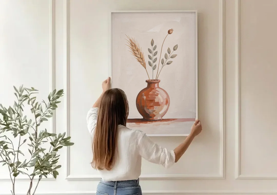 Clay Vase Painting with Three Dried Stems canvas wall art being hung on a paneled wall