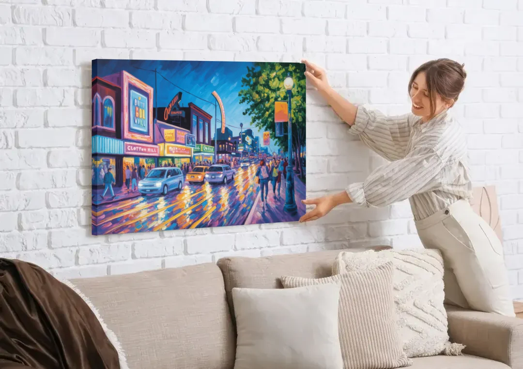 Clifton Hill Neon Lights canvas wall art being hung on a white brick wall above a sofa