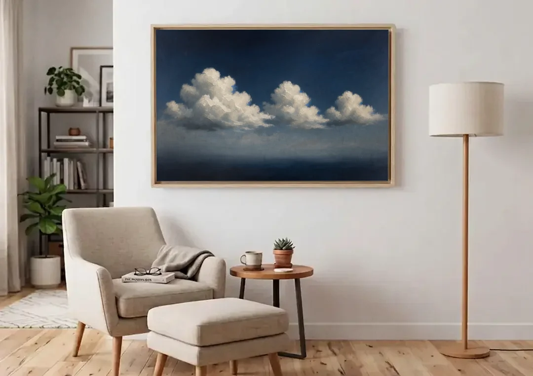 Cloud Wall Art with Three Moonlit Cumulus canvas wall art above an armchair in a bright living room