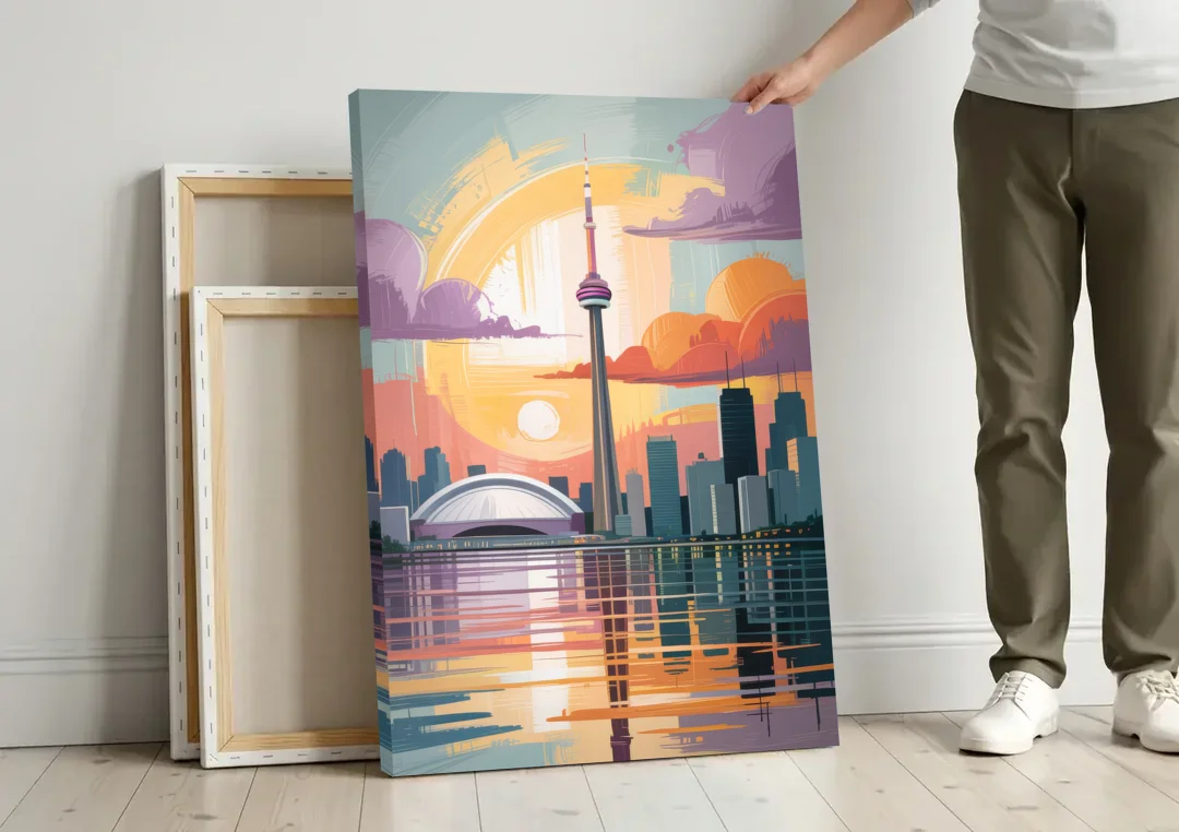 CN Tower Sunset canvas wall art leaning against a wall next to blank canvases