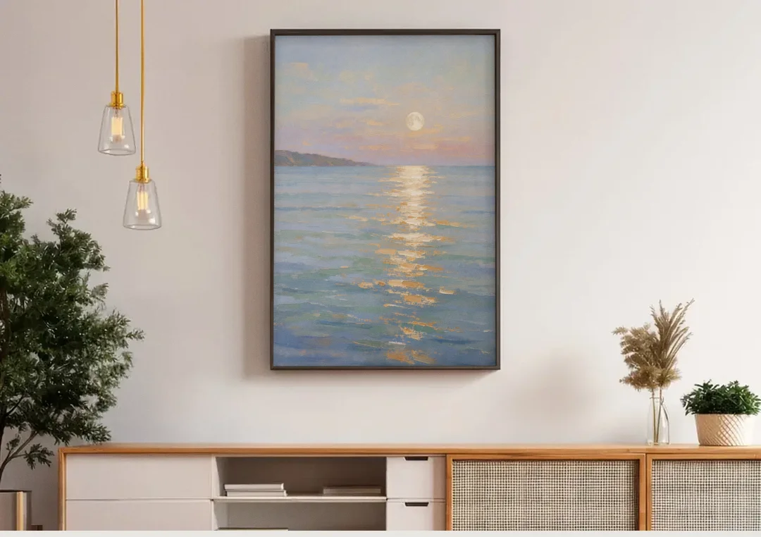Coastal Art Prints Moon Path Over Calm Sea canvas wall art above a wooden sideboard under pendant lights