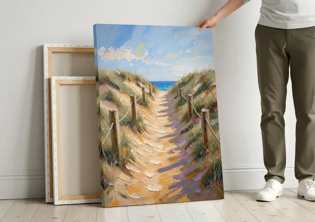 Coastal Beach Path Over the Dune Crest canvas wall art leaning against a wall next to blank canvases