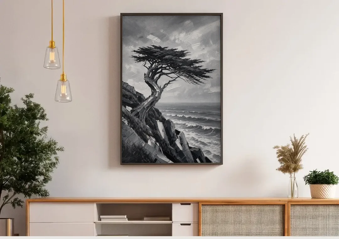 Coastal Black and White Windswept Cypress on the Cliff canvas wall art above a wooden sideboard under pendant lights