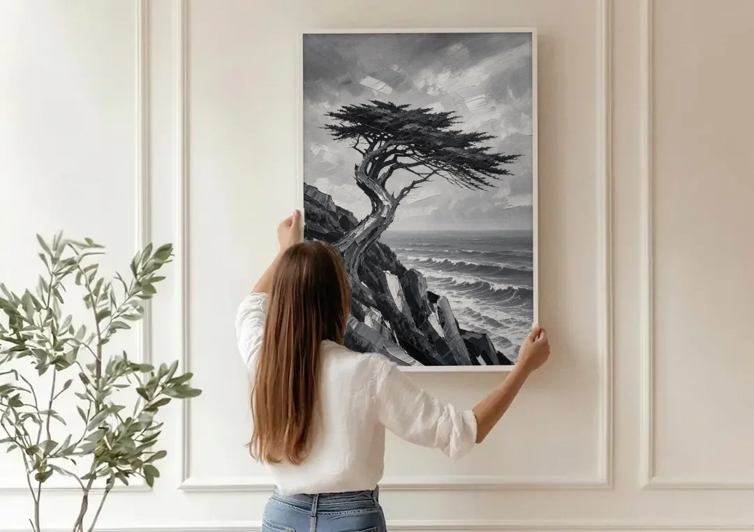 Coastal Black and White Windswept Cypress on the Cliff canvas wall art being hung on a paneled wall