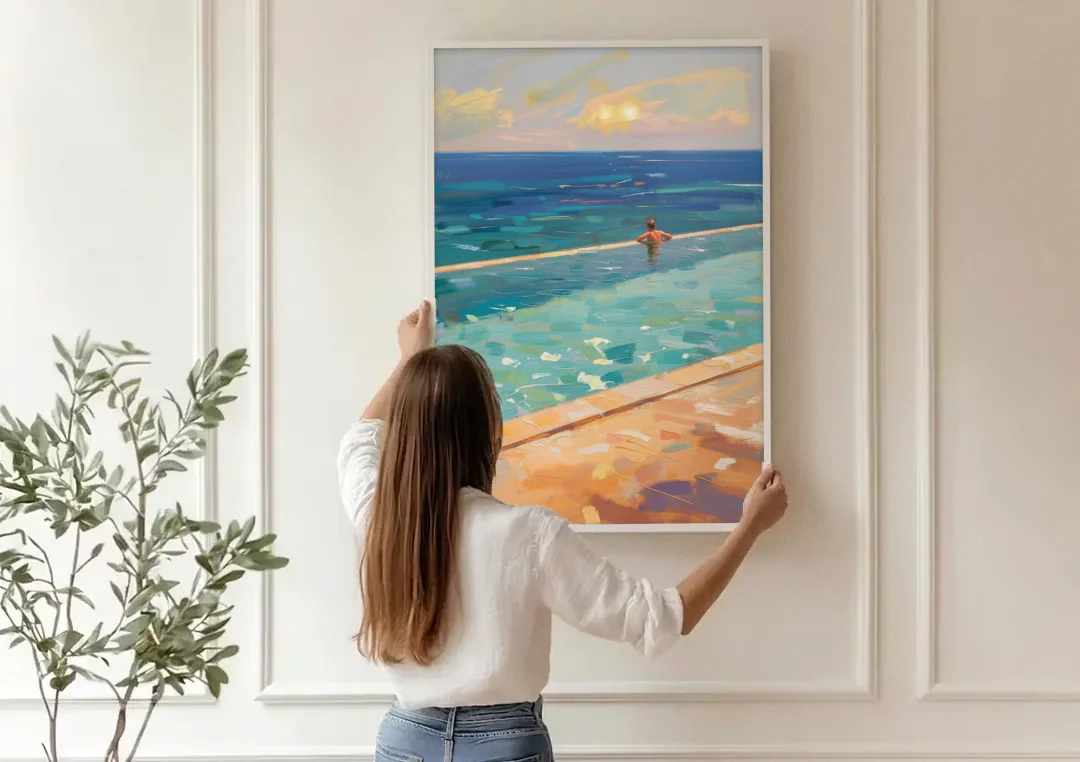 Coastal Modern Wall Art of an Infinity Pool Swimmer canvas wall art being hung on a paneled wall