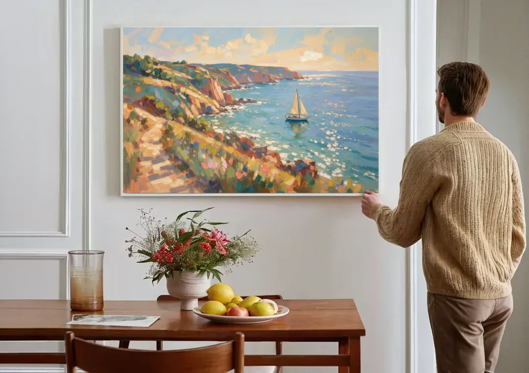 Coastal Wall Art Canvas of Sunlit Cliffs and Sailboat canvas wall art above a dining table