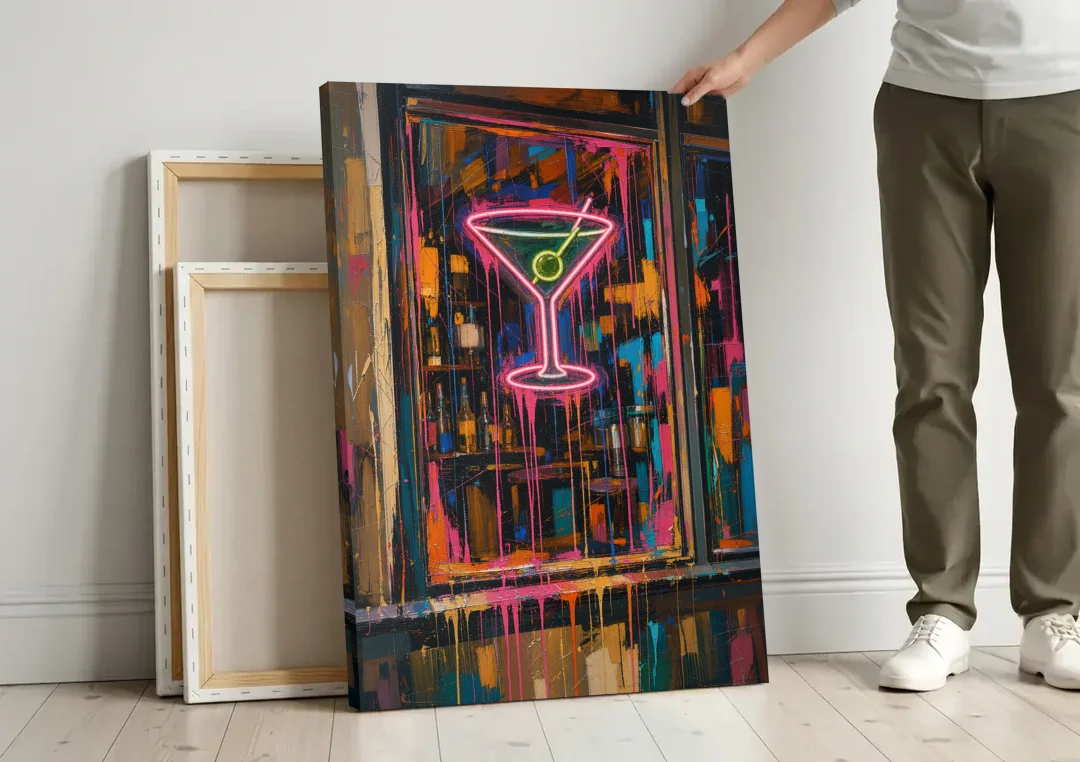 Cocktail Wall Art of a Neon Martini Window canvas wall art leaning against a wall next to blank canvases