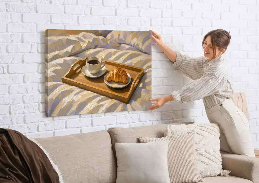 Coffee and Croissant Painting on a Breakfast Tray canvas wall art being hung on a white brick wall above a sofa