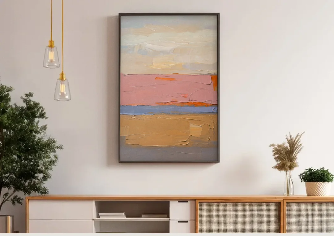 Color Field Abstract Painting in Blush and Ochre canvas wall art above a wooden sideboard under pendant lights