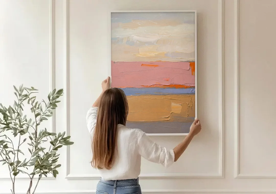 Color Field Abstract Painting in Blush and Ochre canvas wall art being hung on a paneled wall