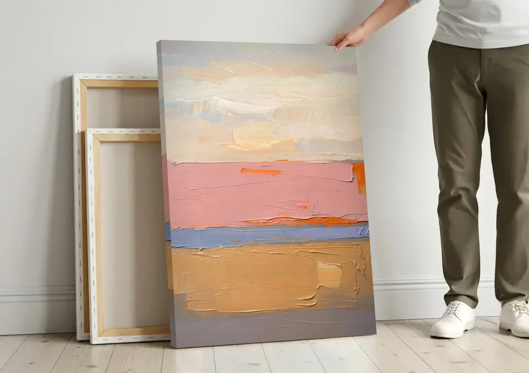 Color Field Abstract Painting in Blush and Ochre canvas wall art leaning against a wall next to blank canvases