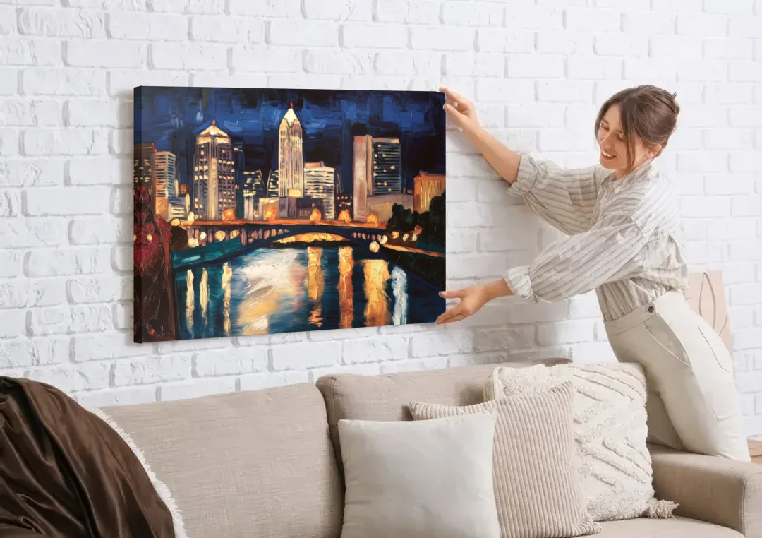 Columbus Nighttime Skyline canvas wall art being hung on a white brick wall above a sofa