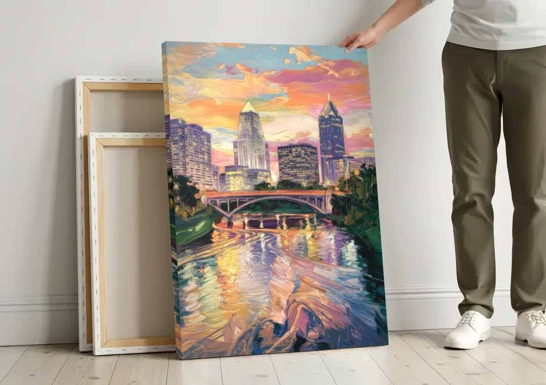 Columbus Scioto River View canvas wall art leaning against a wall next to blank canvases