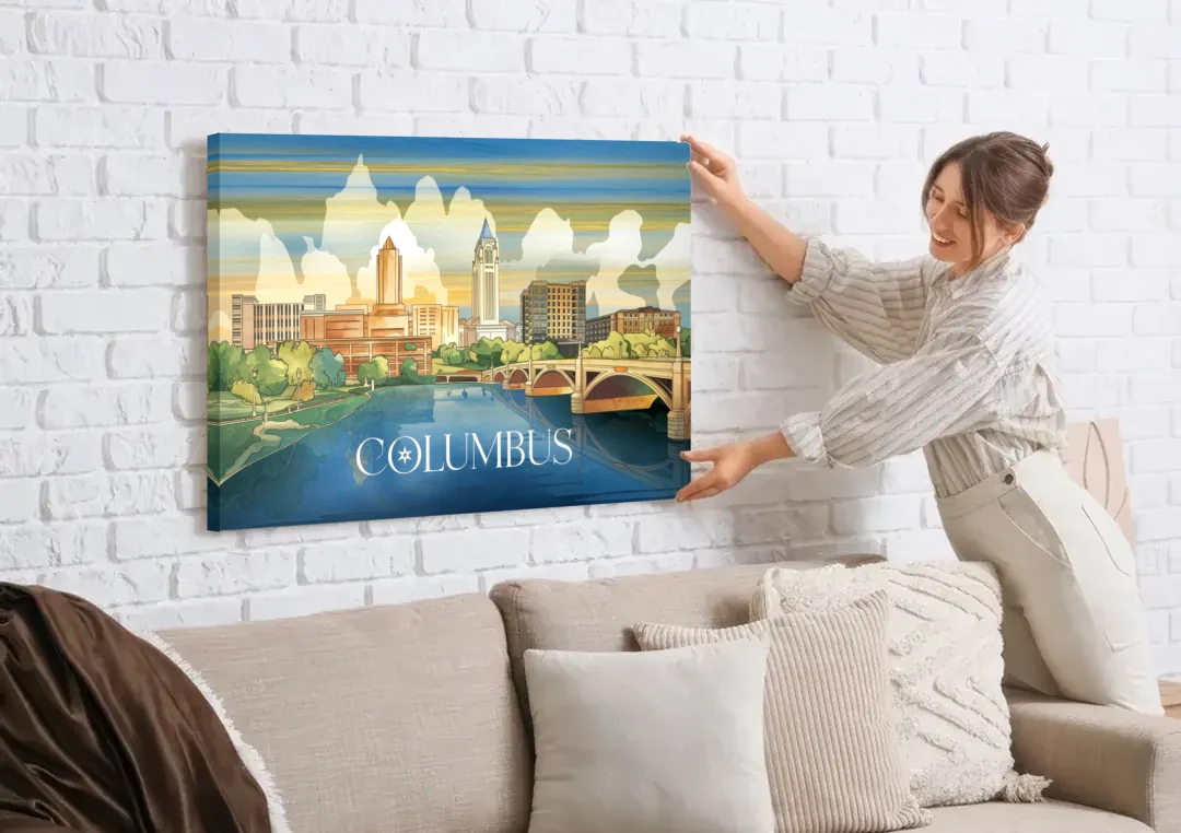 Columbus Urban Charm canvas wall art being hung on a white brick wall above a sofa
