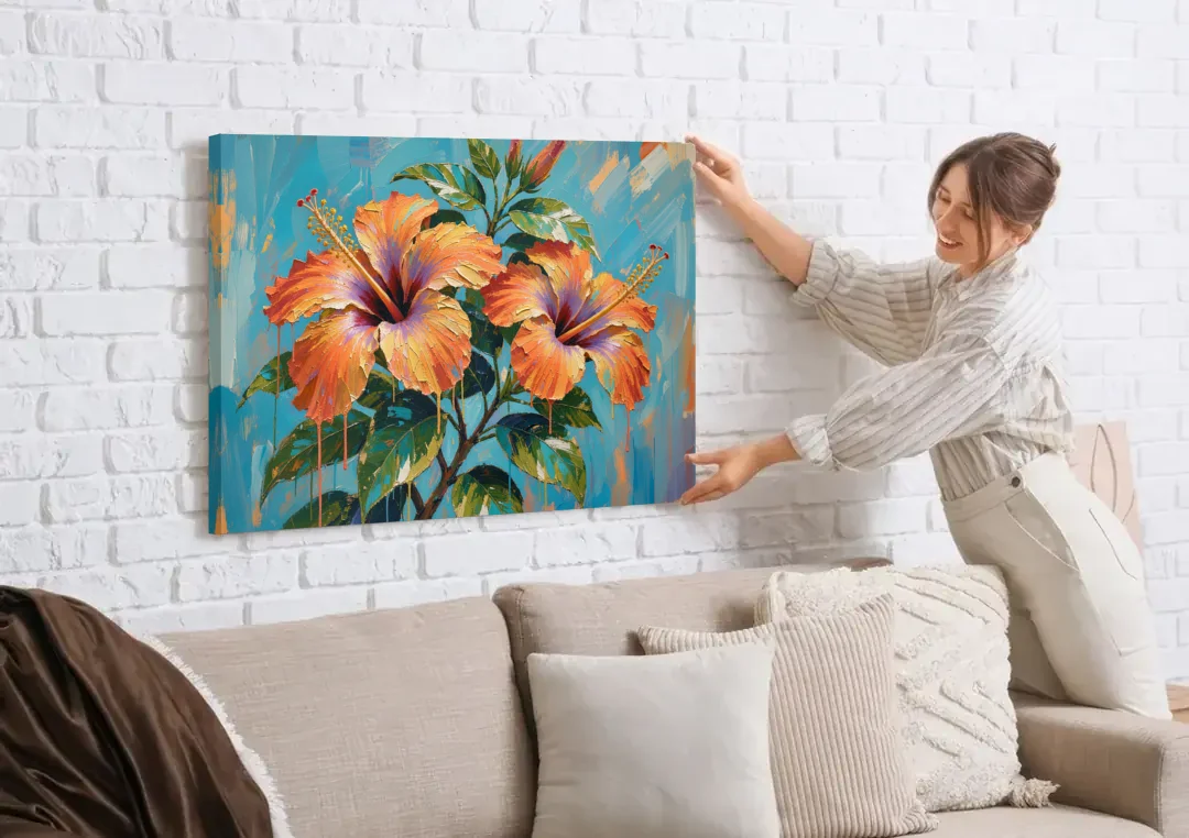 Contemporary Floral Painting of Coral Hibiscus canvas wall art being hung on a white brick wall above a sofa