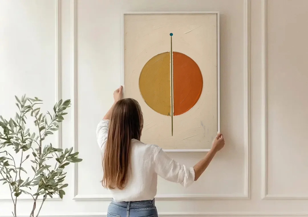 Contemporary Geometric Painting of a Divided Circle canvas wall art being hung on a paneled wall
