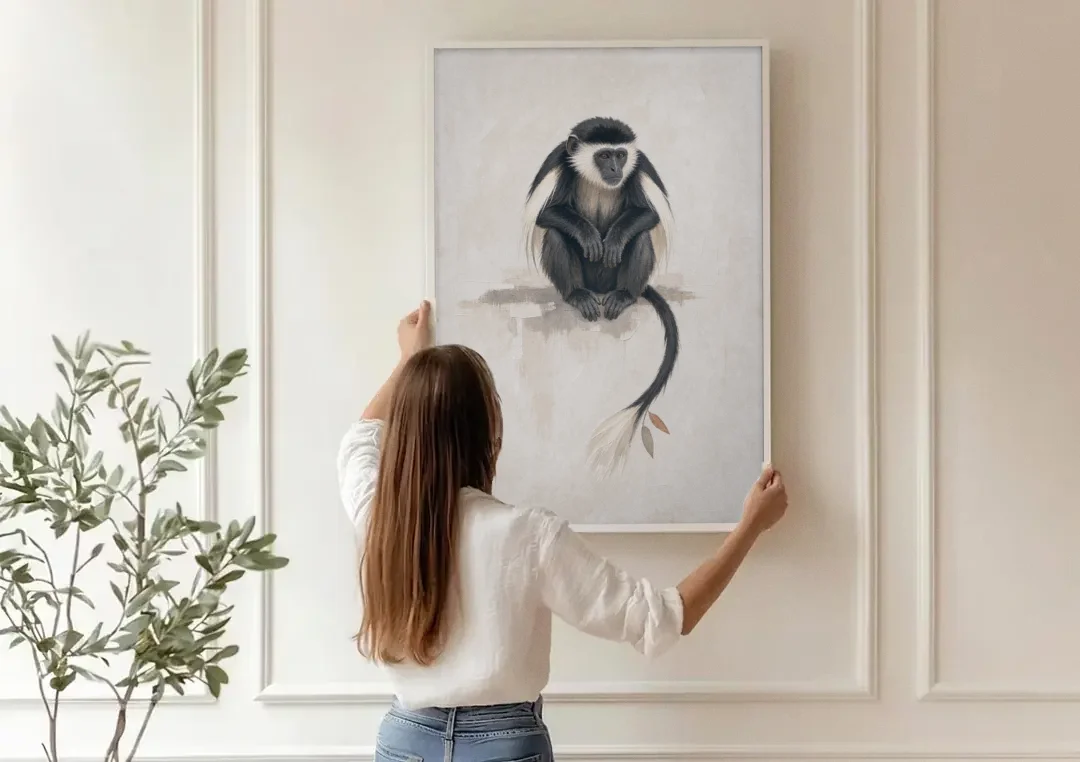 Contemporary Nursery Wall Art with a Colobus Monkey canvas wall art being hung on a paneled wall