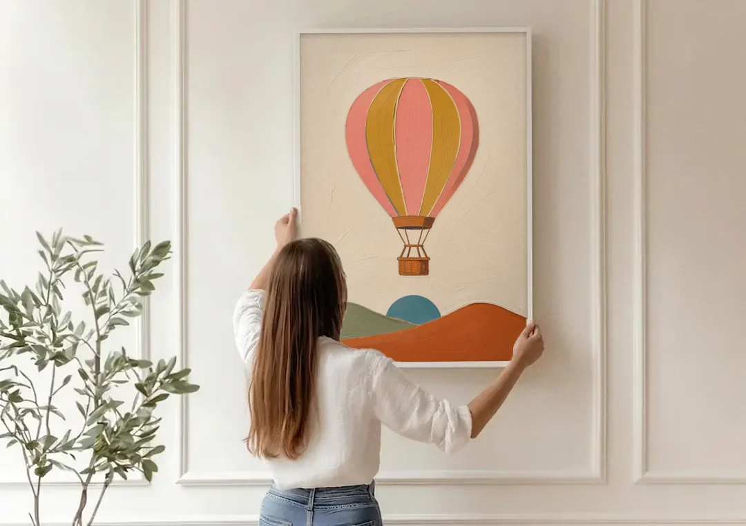 Coral Wall Art with a Striped Hot Air Balloon canvas wall art being hung on a paneled wall