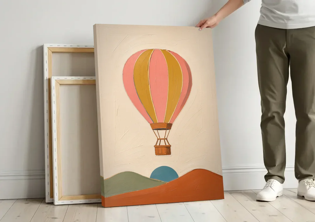 Coral Wall Art with a Striped Hot Air Balloon canvas wall art leaning against a wall next to blank canvases