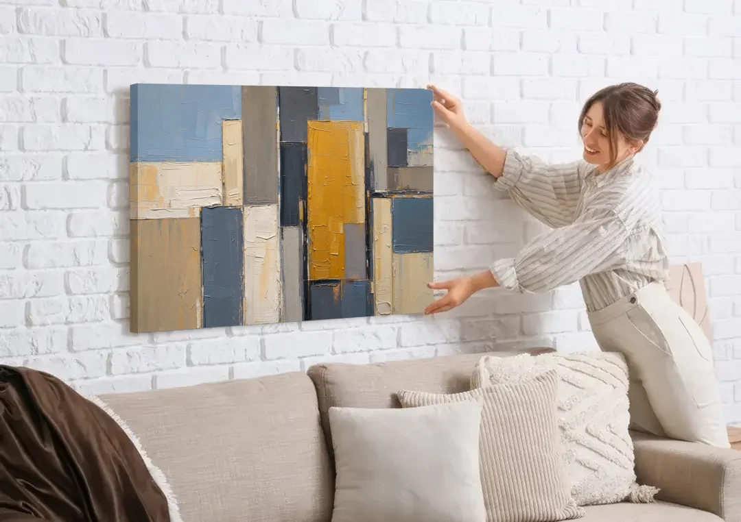 Corporate Office Wall Art of an Ochre Facade canvas wall art being hung on a white brick wall above a sofa