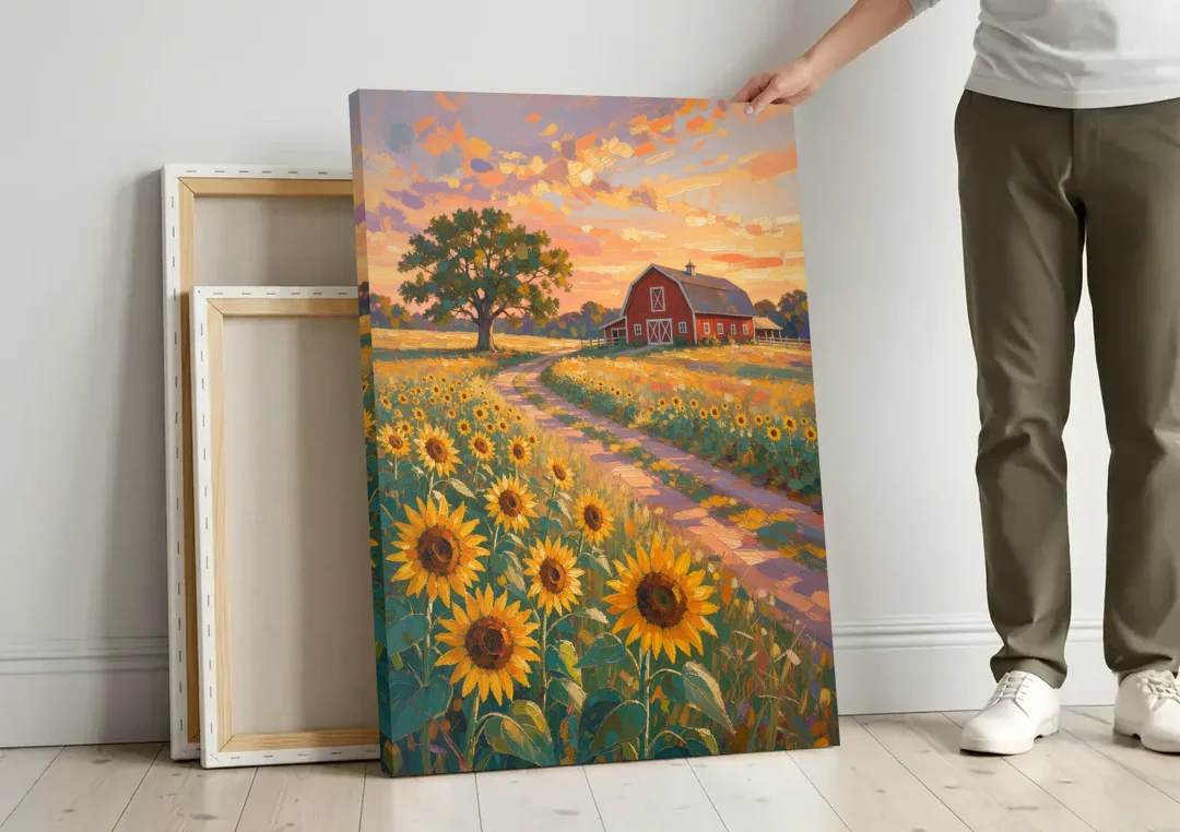 Country Sunflower Painting with Red Barn and Oak canvas wall art leaning against a wall next to blank canvases