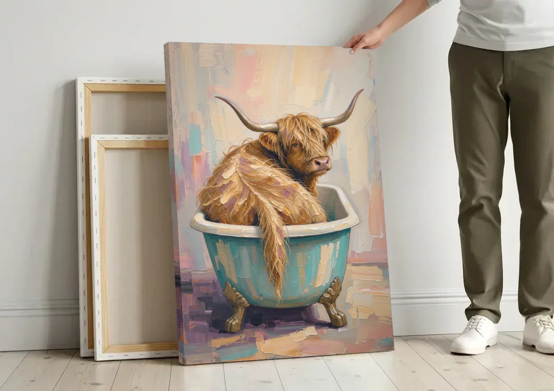 Cow in Bathtub Wall Art with a Backward Glance canvas wall art leaning against a wall next to blank canvases
