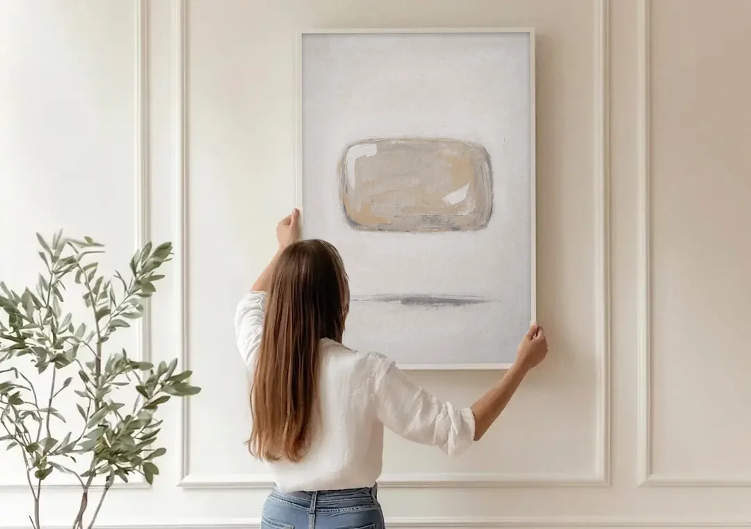 Cream Wall Art with Floating Birch Bark Stone canvas wall art being hung on a paneled wall