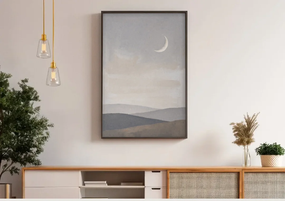 Crescent Moon Above Hazy Gray Hills canvas wall art above a wooden sideboard under pendant lights