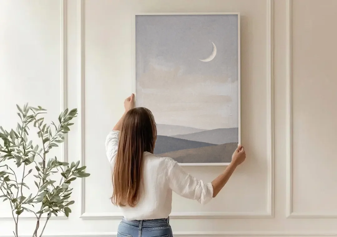 Crescent Moon Above Hazy Gray Hills canvas wall art being hung on a paneled wall