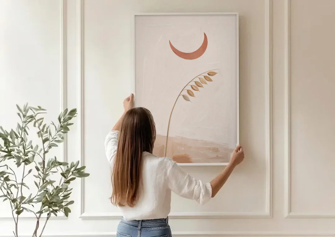 Crescent Moon Painting with a Bowing Grass Stem canvas wall art being hung on a paneled wall