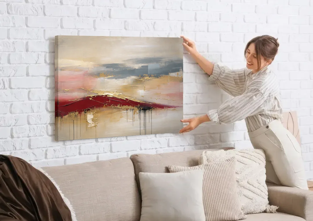 Crimson Ridge with Gold Seams in Ivory Haze canvas wall art being hung on a white brick wall above a sofa