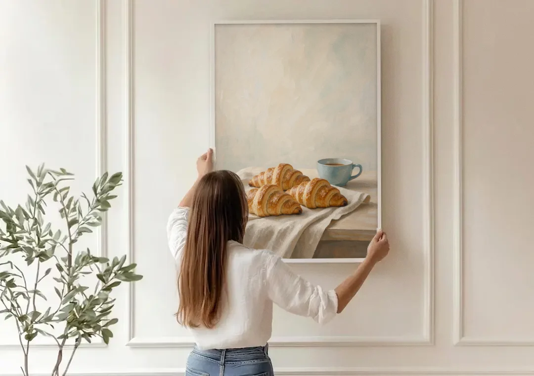 Croissant Painting with French Blue Coffee Cup canvas wall art being hung on a paneled wall