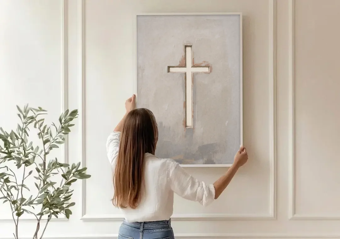 Cross Canvas Painting of Light Through Plaster canvas wall art being hung on a paneled wall