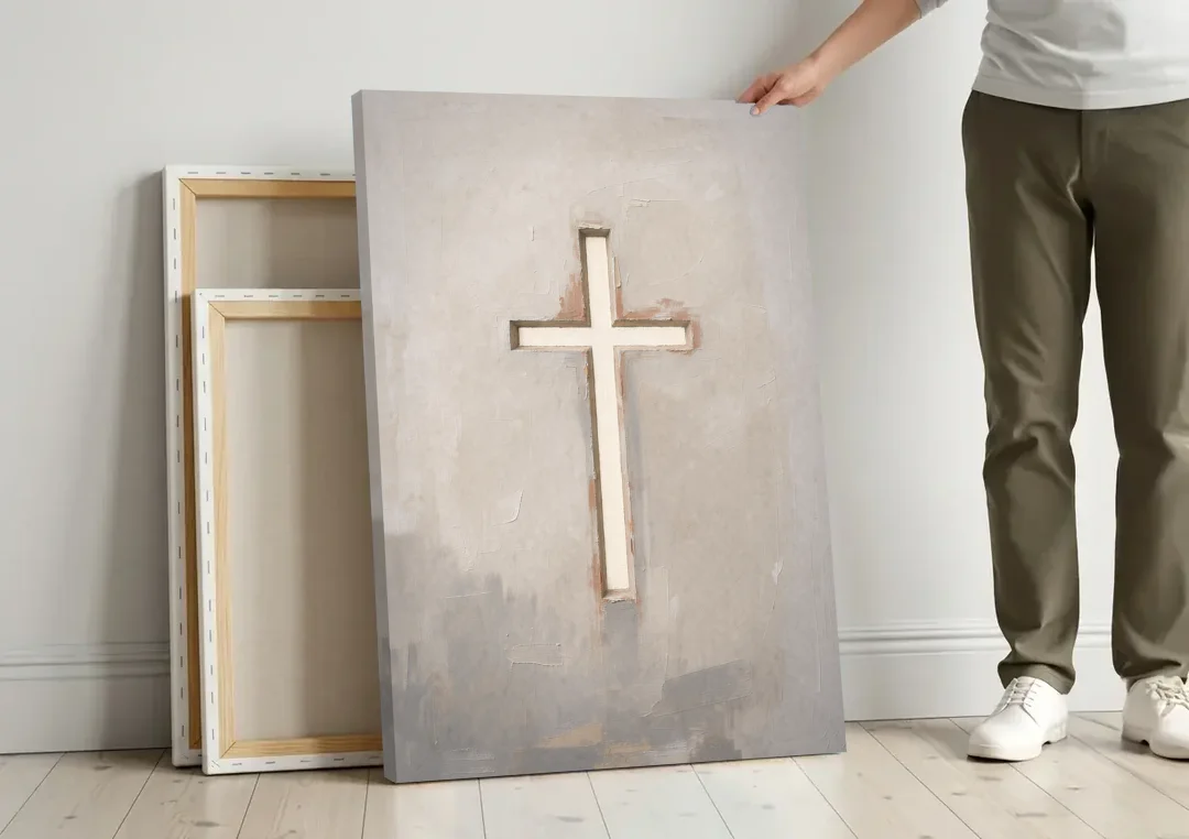 Cross Canvas Painting of Light Through Plaster canvas wall art leaning against a wall next to blank canvases