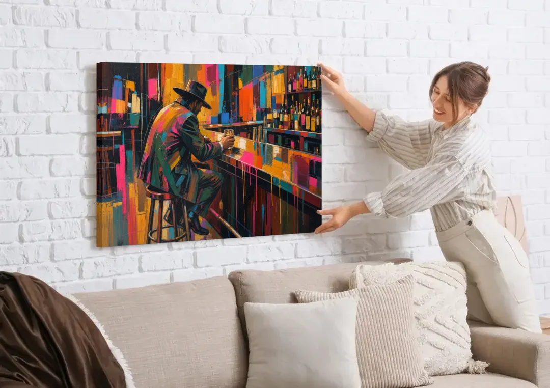 Cubism Wall Art of a Lone Whiskey Drinker canvas wall art being hung on a white brick wall above a sofa