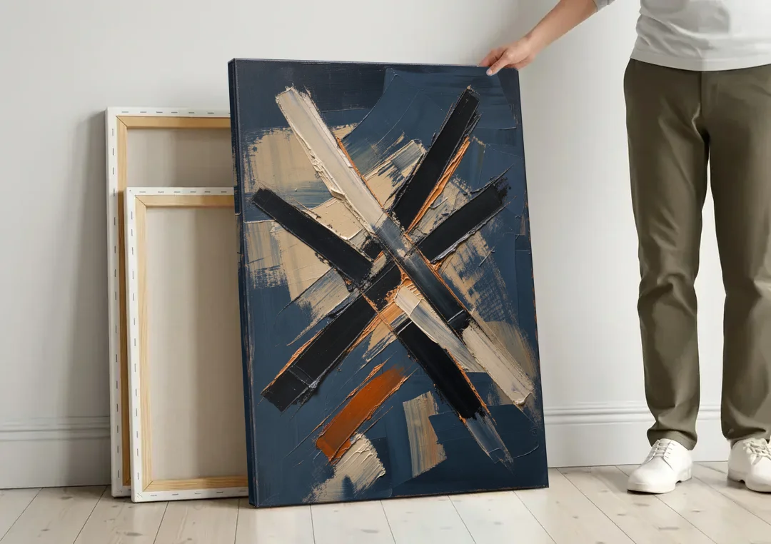 Dark Abstract Copper Crossings in Navy canvas wall art leaning against a wall next to blank canvases