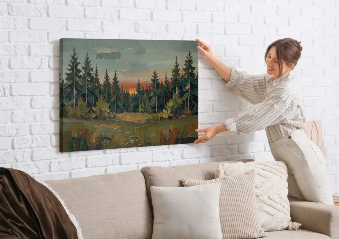 Dark Green Painting of Pines at Dusk canvas wall art being hung on a white brick wall above a sofa