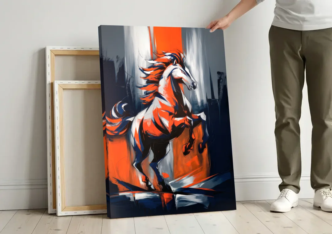 Denver Broncos Legacy canvas wall art leaning against a wall next to blank canvases