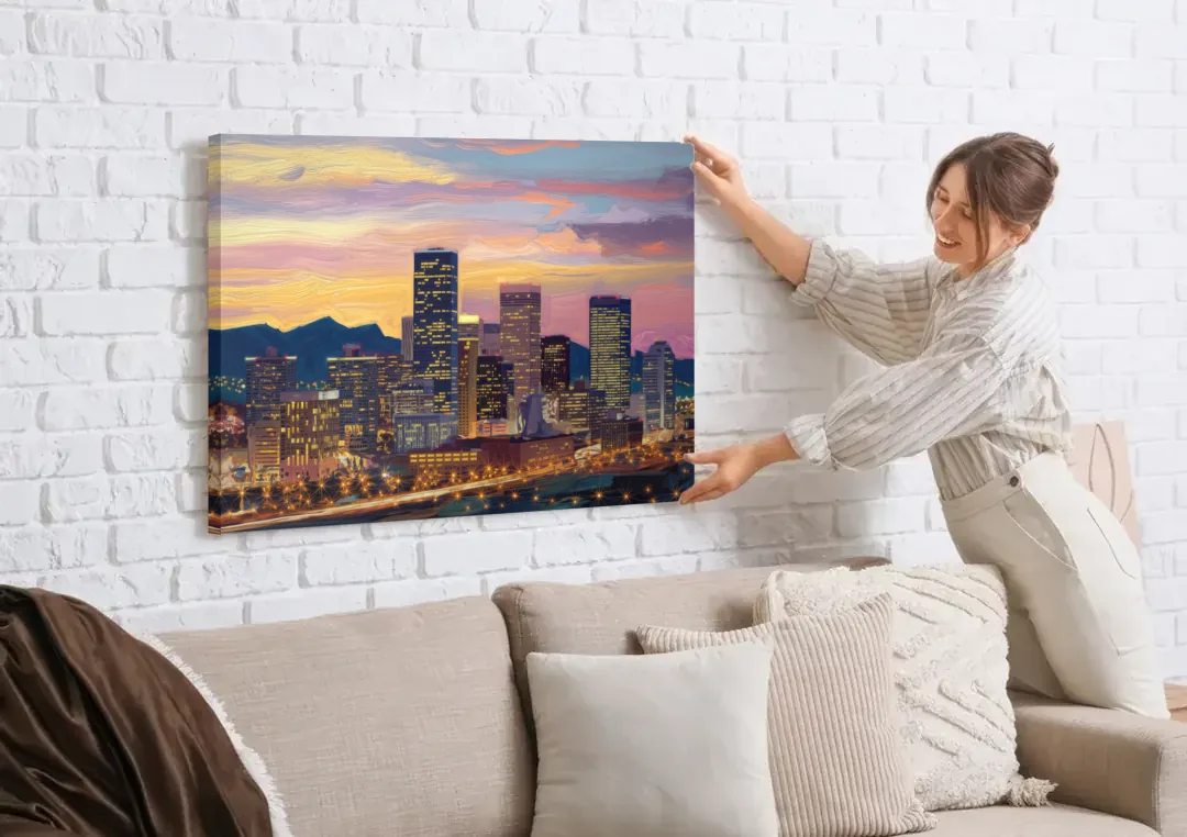 Denver Skyline At Dusk canvas wall art being hung on a white brick wall above a sofa