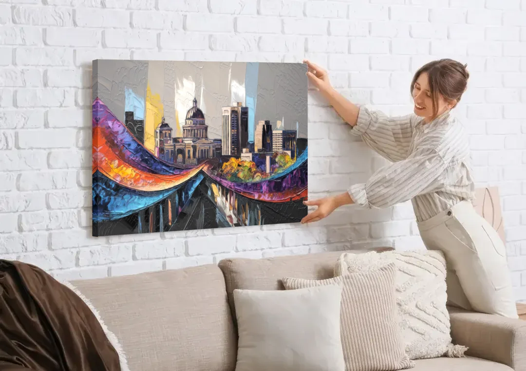 Des Moines Historic Landmarks canvas wall art being hung on a white brick wall above a sofa