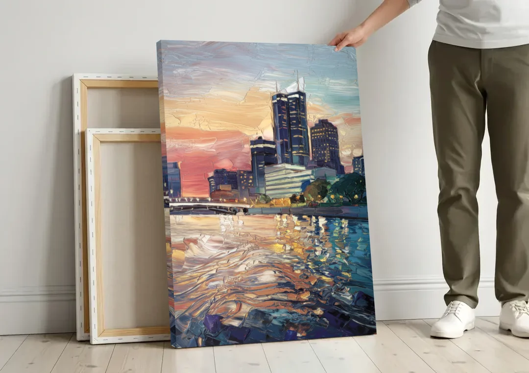 Detroit Riverfront View canvas wall art leaning against a wall next to blank canvases