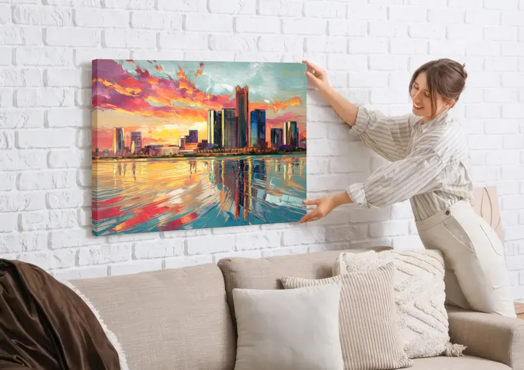 Detroit Skyline At Sunset canvas wall art being hung on a white brick wall above a sofa