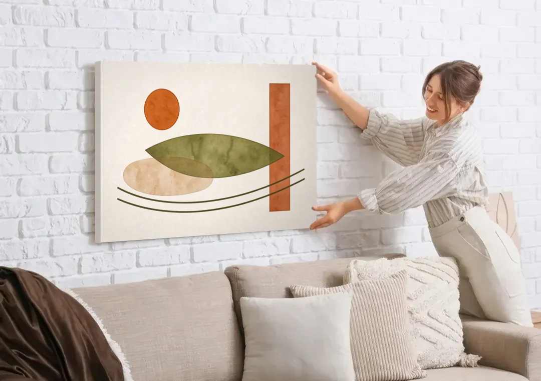 Dining Room Abstract Art with Horizontal Olive Leaf canvas wall art being hung on a white brick wall above a sofa