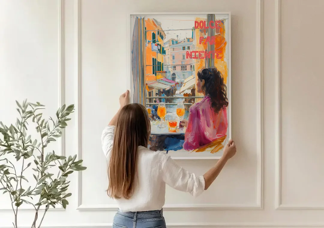 Dolce Far Niente Painting with a Spritz canvas wall art being hung on a paneled wall